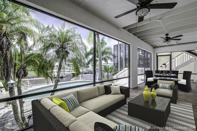 sunroom featuring ceiling fan