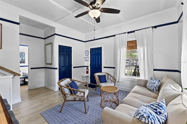 living room featuring ceiling fan, ornamental molding, and light hardwood / wood-style floors