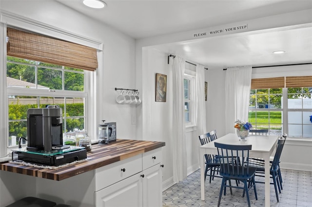 tiled dining area with a healthy amount of sunlight