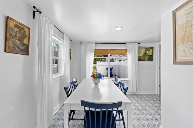 dining room featuring light tile patterned flooring and a wealth of natural light