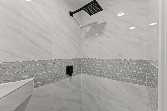 bathroom featuring tile walls and a tile shower