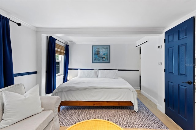 bedroom with light wood-type flooring and ornamental molding