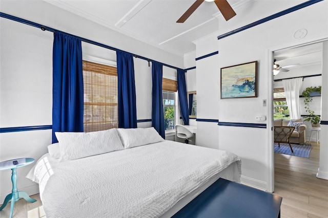 bedroom featuring ceiling fan, light hardwood / wood-style flooring, and ornamental molding