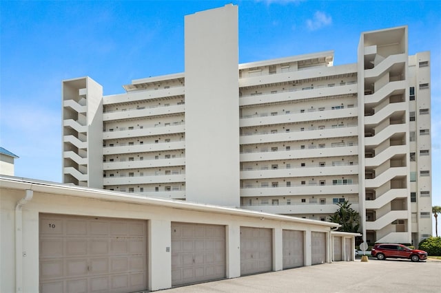 view of building exterior featuring community garages