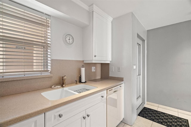 kitchen with light countertops, white dishwasher, a sink, and white cabinets