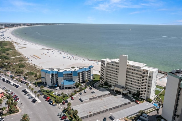 drone / aerial view featuring a water view and a beach view