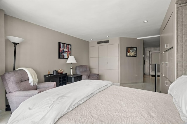 bedroom featuring a closet, light tile patterned flooring, visible vents, and recessed lighting