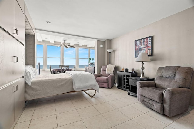 bedroom featuring a water view and light tile patterned floors