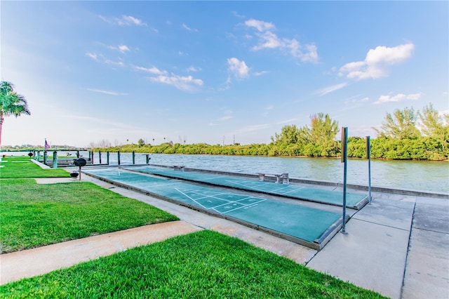 surrounding community featuring a water view and a lawn