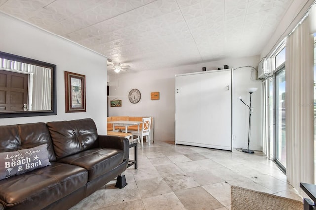 living room with an AC wall unit and ceiling fan