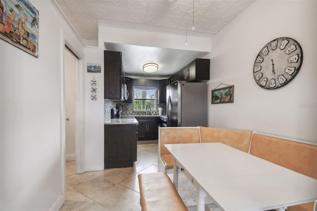 tiled dining space featuring sink