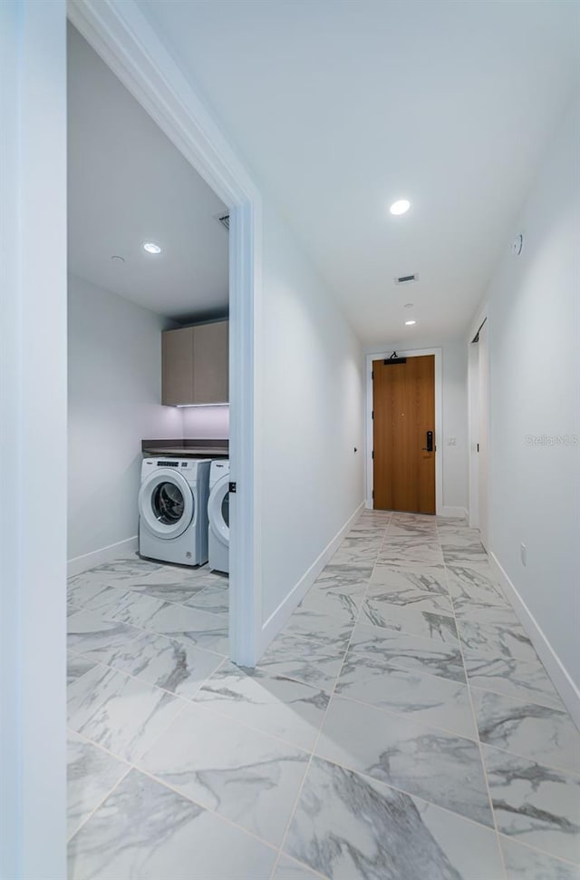 corridor featuring separate washer and dryer