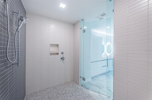 bathroom with a shower with door