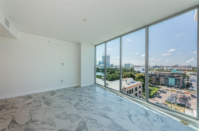 empty room featuring a wall of windows