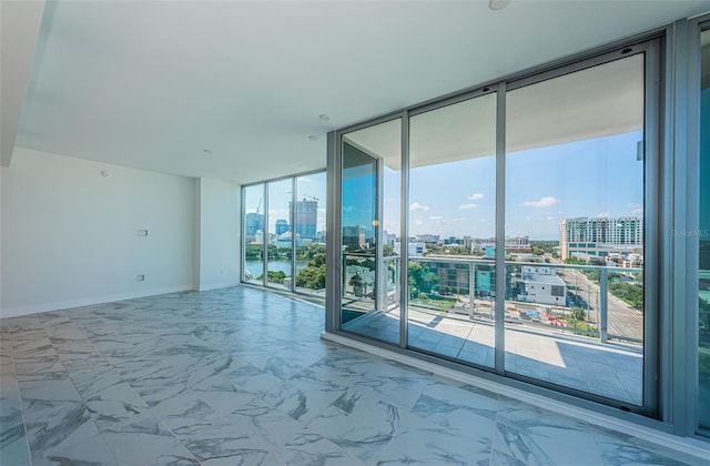 unfurnished room with floor to ceiling windows