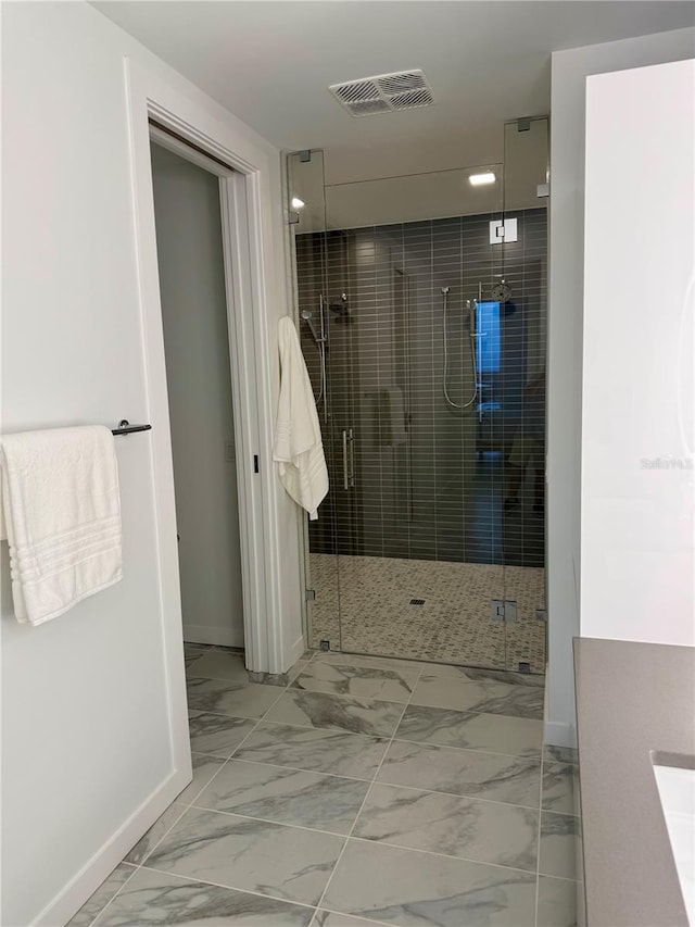 bathroom featuring vanity and a shower with shower door