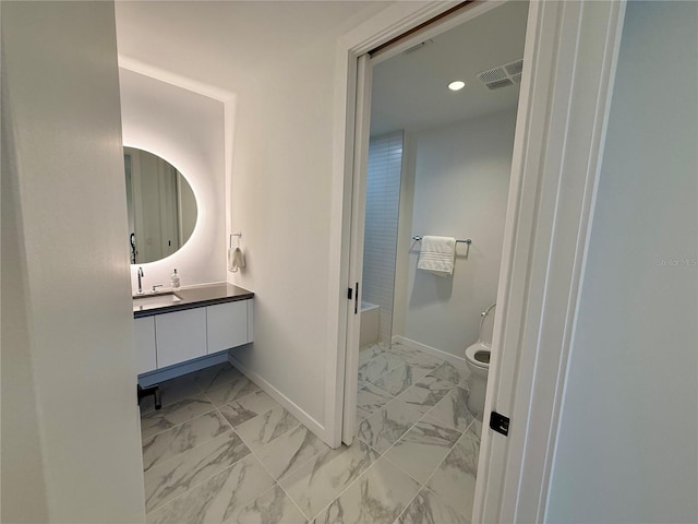 bathroom featuring marble finish floor, visible vents, toilet, vanity, and baseboards