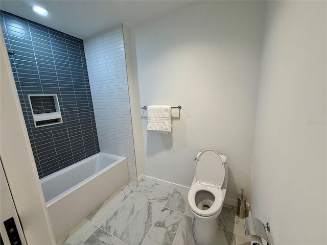 bathroom with toilet, marble finish floor, bathtub / shower combination, and baseboards