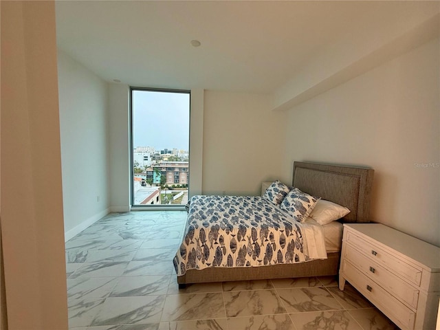 bedroom featuring expansive windows, marble finish floor, access to outside, and baseboards