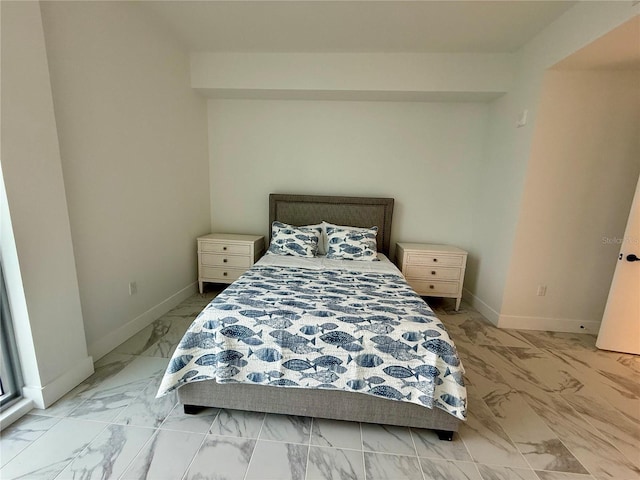 bedroom featuring marble finish floor and baseboards