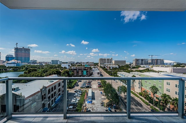 balcony featuring a view of city and a water view