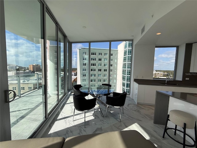 balcony featuring a view of city, visible vents, and a sink