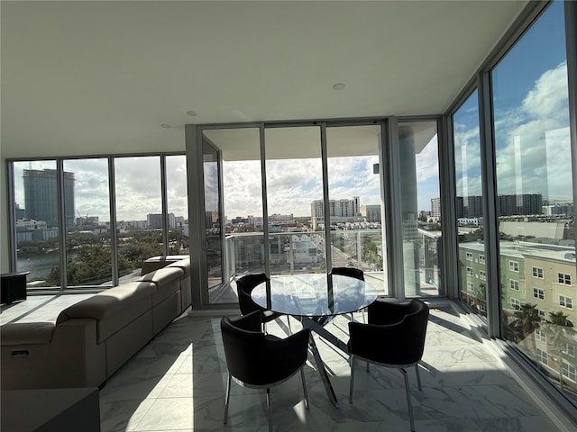 sunroom featuring a healthy amount of sunlight and a city view