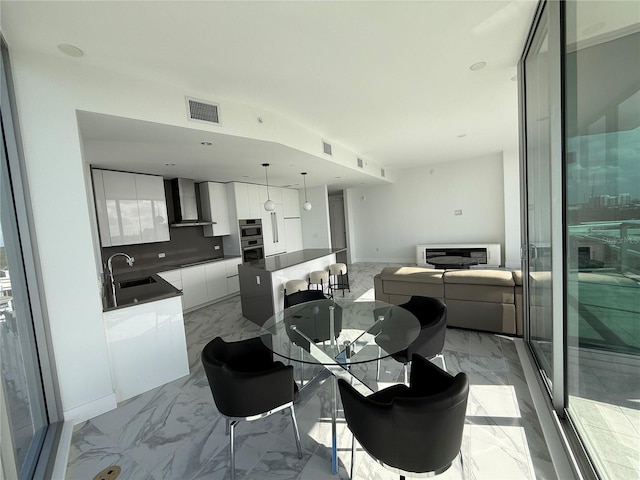 interior space with marble finish floor, visible vents, and baseboards