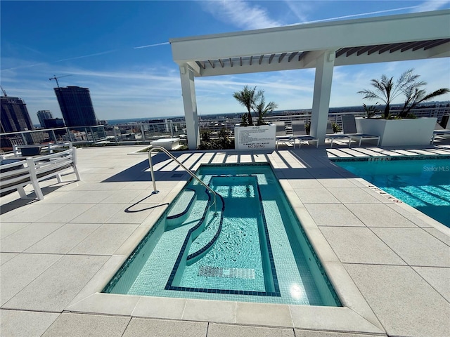 pool featuring a patio area and a city view