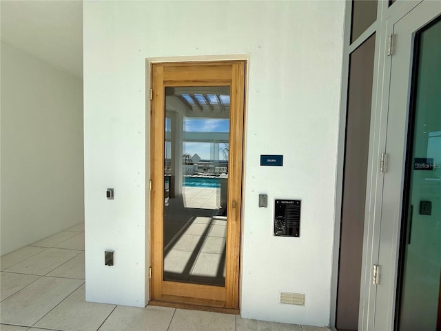 hall featuring light tile patterned floors