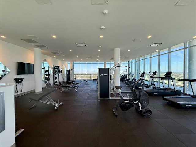 exercise room with visible vents, a wall of windows, and recessed lighting