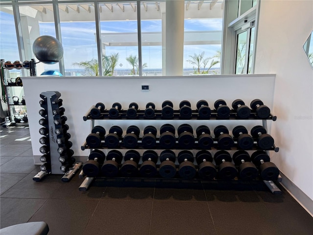 gym with baseboards and a wealth of natural light