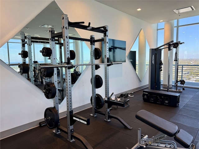 workout area featuring a wall of windows and visible vents