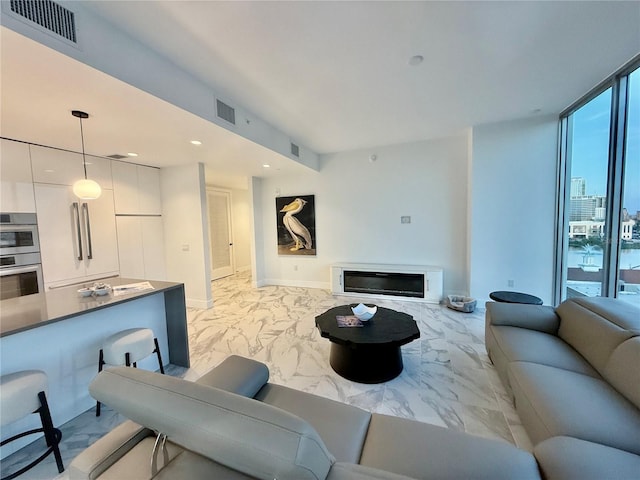 777 3rd Ave N Unit 908, Saint Petersburg, FL 33701 - living area with light marble finish floors, recessed lighting, and baseboards