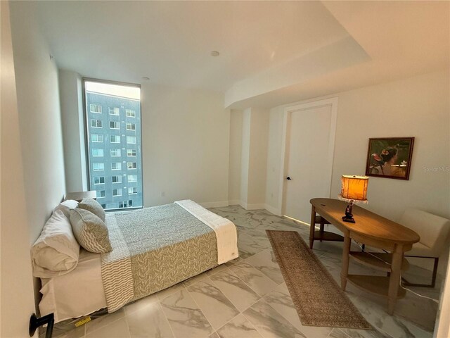 777 3rd Ave N Unit 908, Saint Petersburg, FL 33701 - bedroom with light marble finish floors and a wall of windows