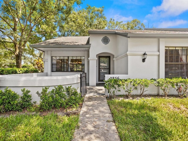 view of front of house featuring a fenced front yard and stucco siding