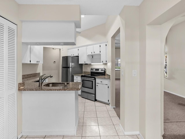 kitchen with light colored carpet, appliances with stainless steel finishes, white cabinets, a sink, and dark stone counters