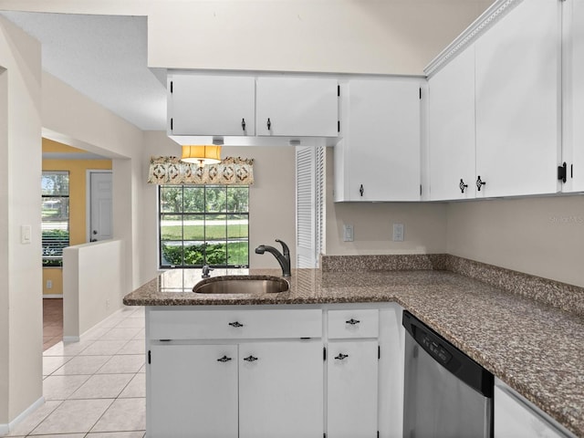 kitchen with dark stone counters, dishwasher, white cabinets, and sink