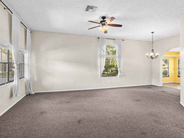 carpeted spare room featuring visible vents, plenty of natural light, and baseboards