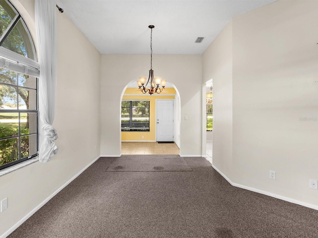 foyer with an inviting chandelier, baseboards, visible vents, and light colored carpet