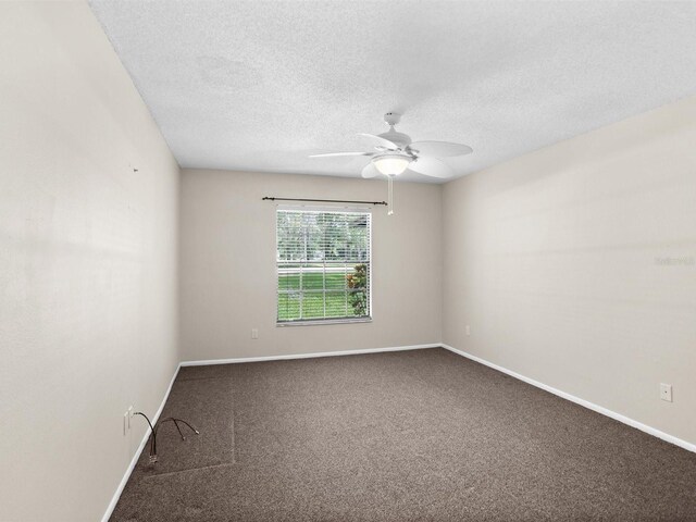 unfurnished room featuring a textured ceiling, ceiling fan, and carpet flooring