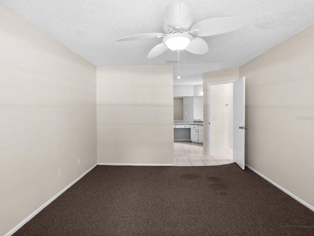 interior space featuring ensuite bath, light tile patterned floors, and ceiling fan