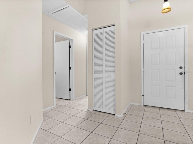 foyer entrance with light tile patterned flooring