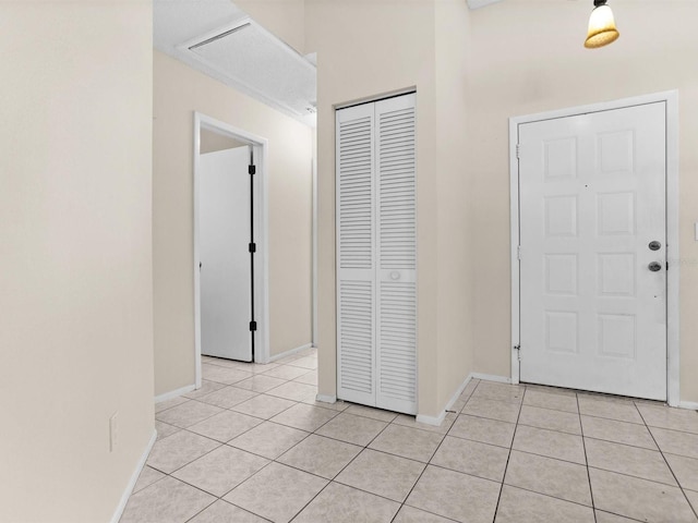 entryway featuring baseboards and light tile patterned flooring