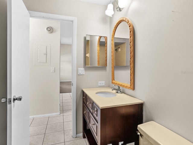 bathroom with baseboards, vanity, toilet, and tile patterned floors