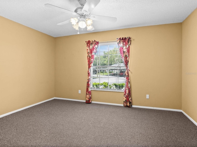 unfurnished room with carpet floors, a textured ceiling, baseboards, and a ceiling fan