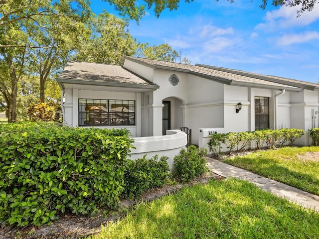 view of front of property with a front lawn and stucco siding