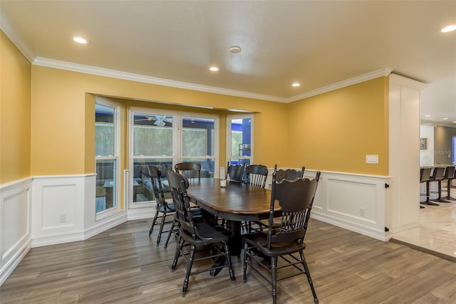 dining area featuring hardwood / wood-style floors and ornamental molding