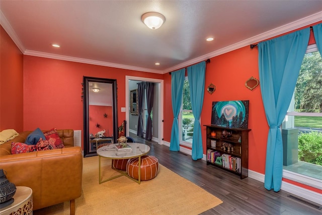 living room with dark hardwood / wood-style flooring and ornamental molding