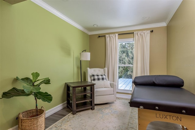 sitting room featuring wood-type flooring and ornamental molding